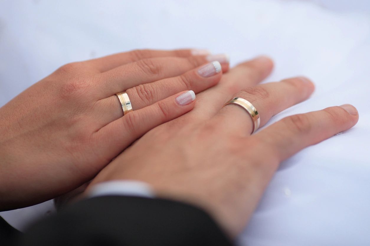 Closeup of hands of a couple in engagement rings