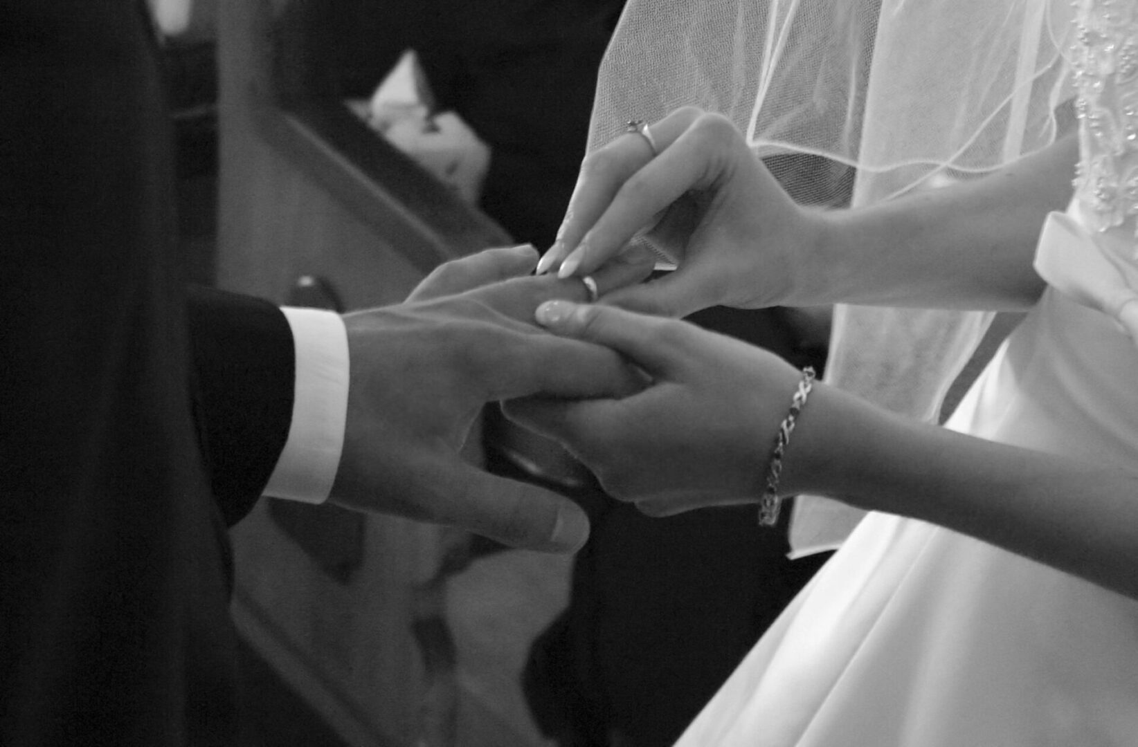 bride and groom are exchanging their rings
