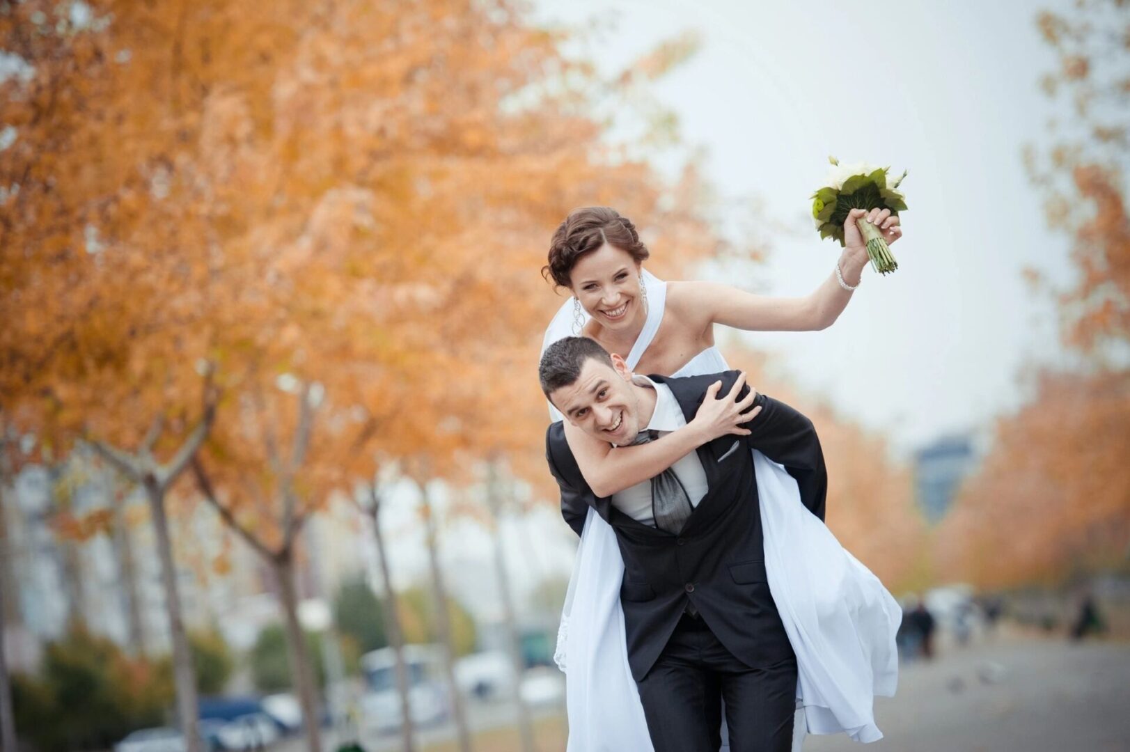 a groom carrying a bride on his back