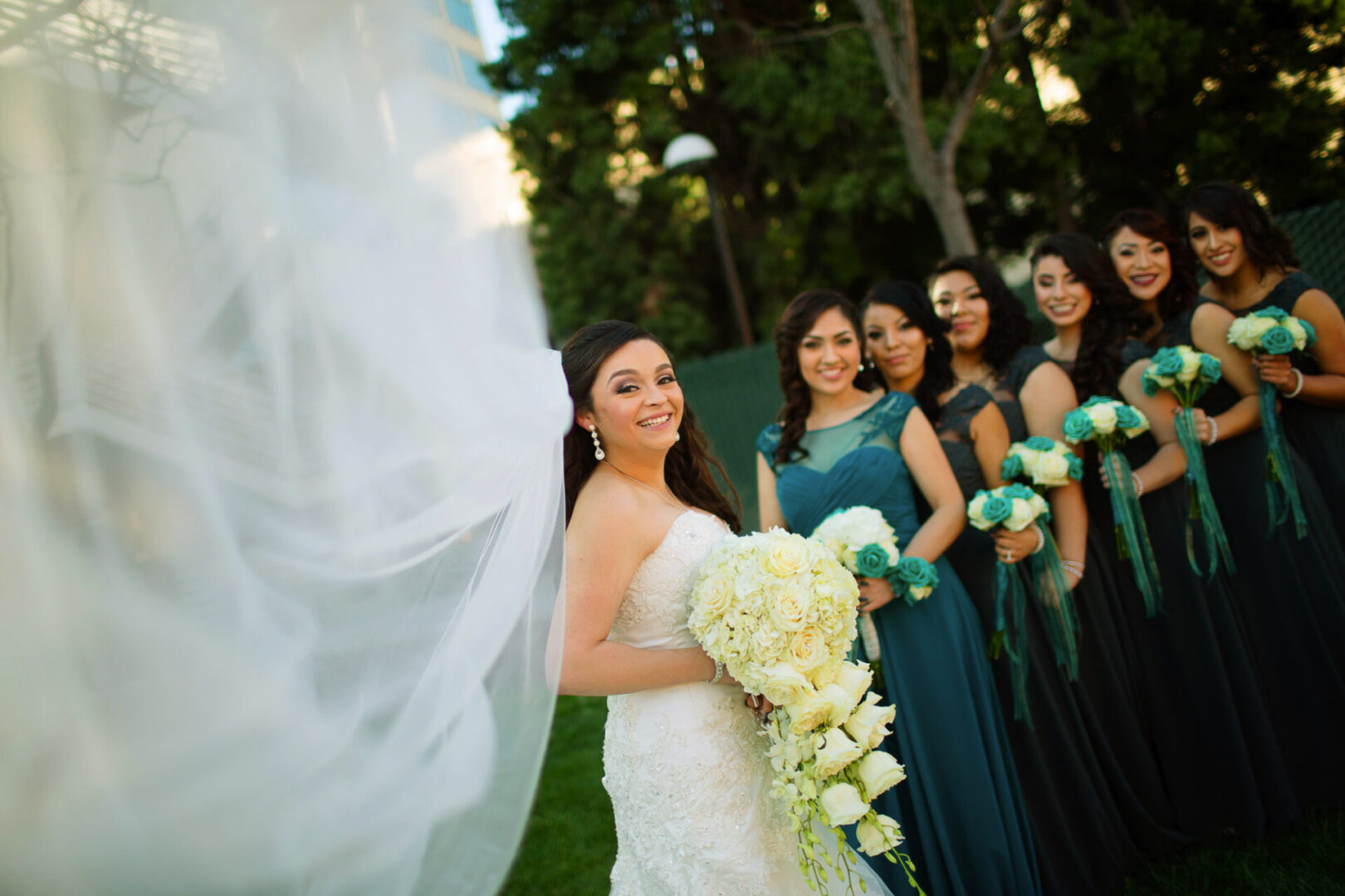A bride standing with so many ladies in a field