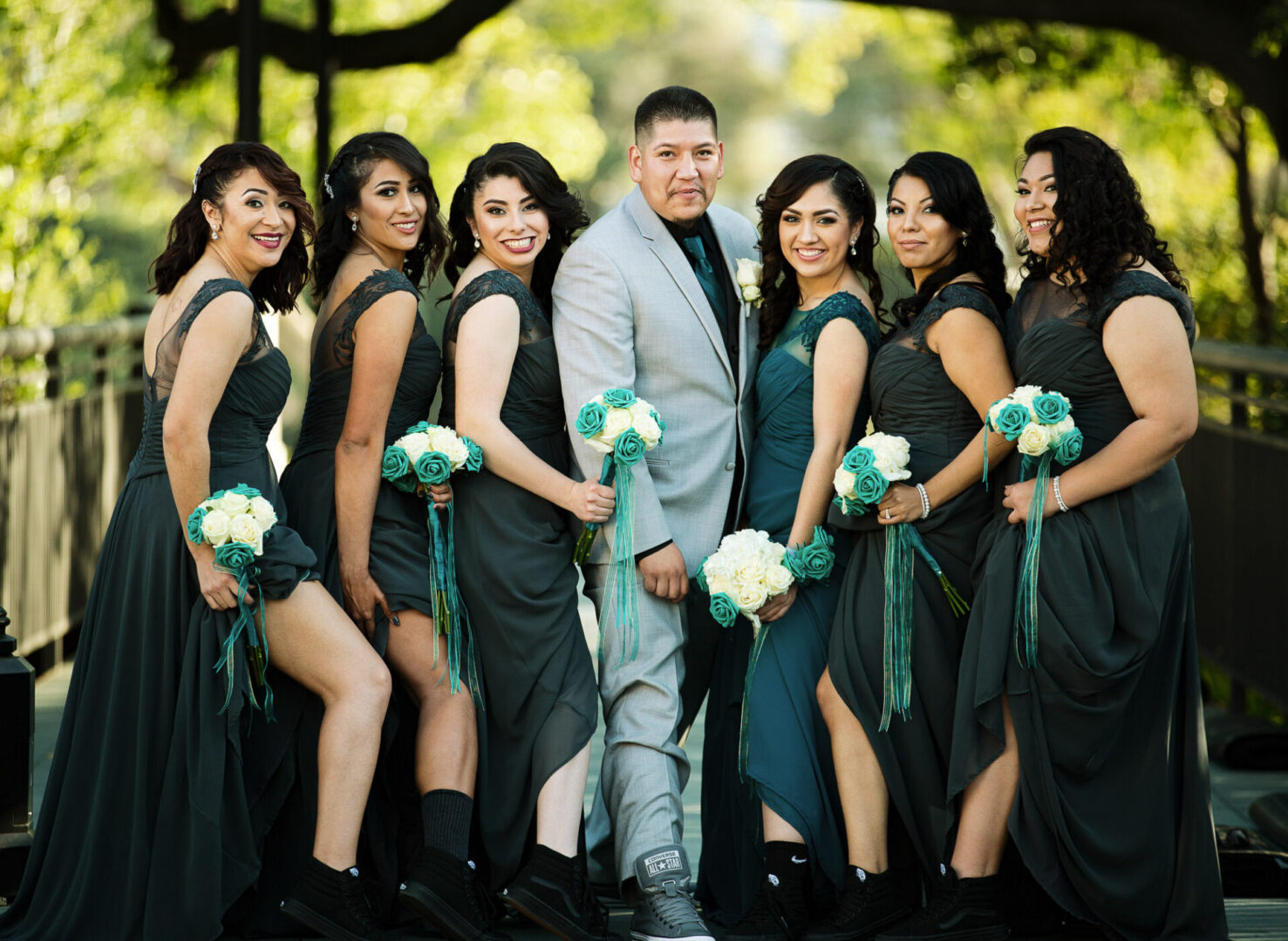 A groom standing with bride and ladies