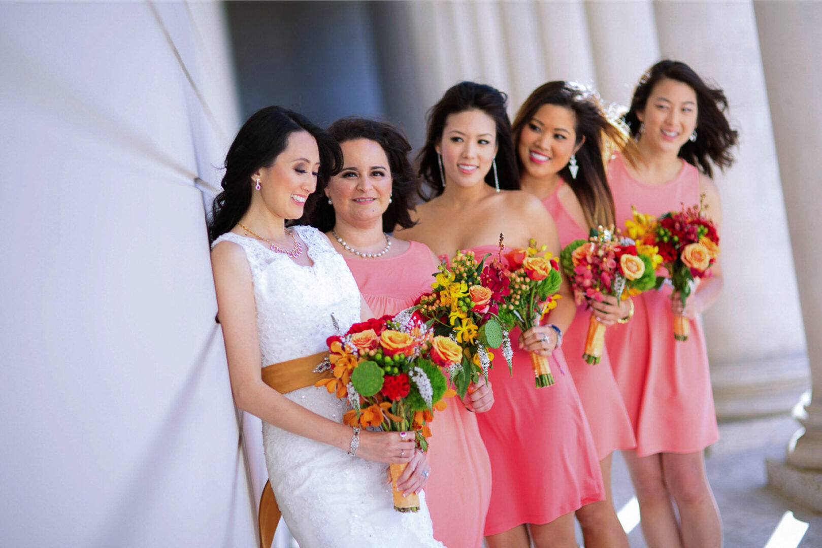 A bride in white dress standing with some other girls