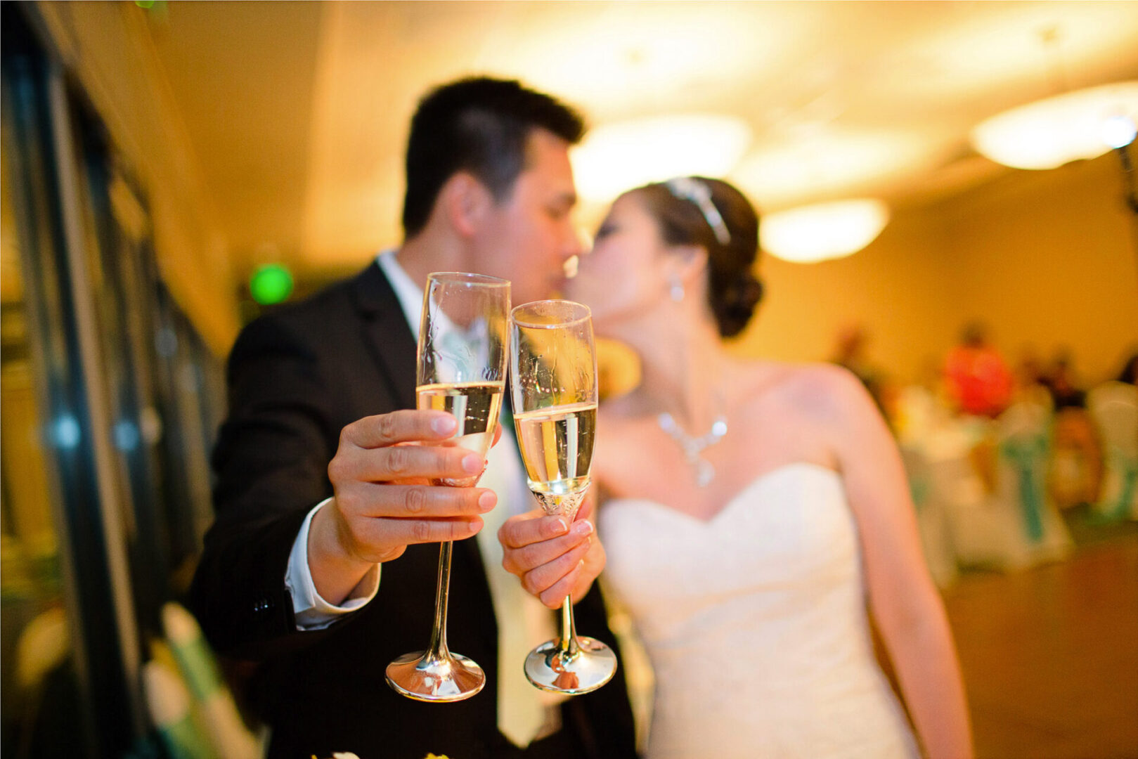 Close up shot of a couple holding a Champaign