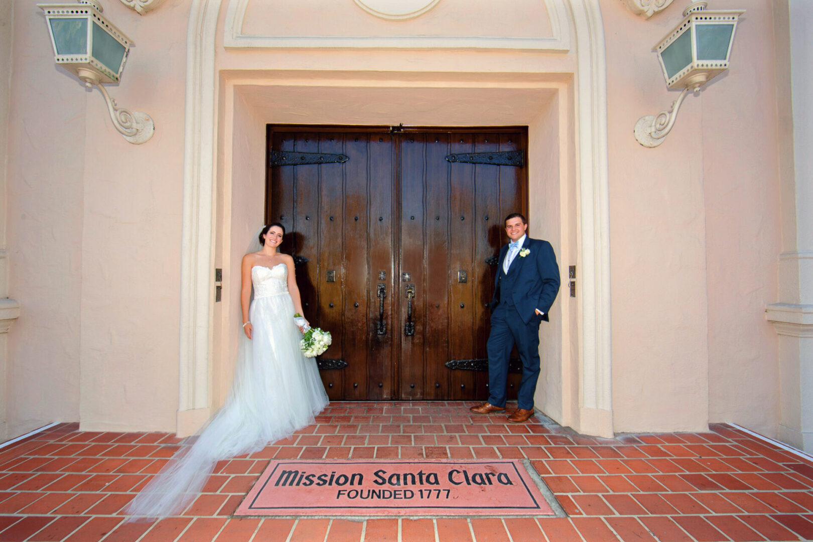 Bride and groom standing near a door