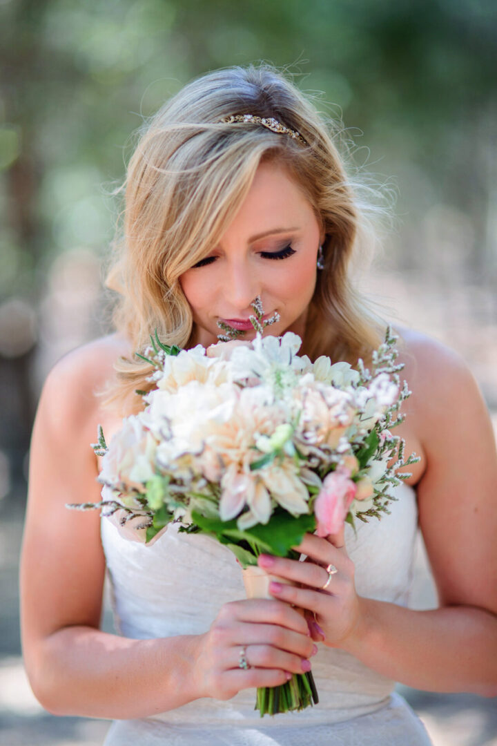 Bride smelling flowers