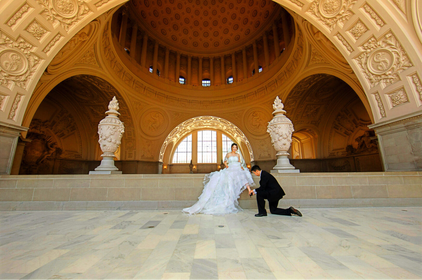 A newly married couple posing inside a hall