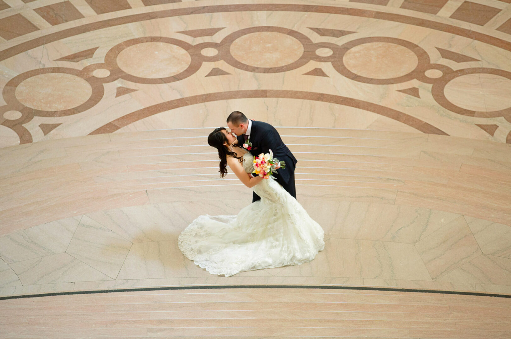 A newly married couple kissing in a kissing on a hall