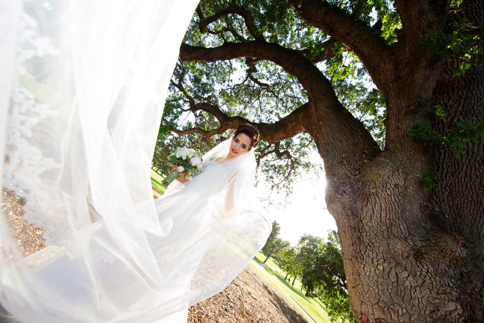 A bride wearing a white color dress in a ground